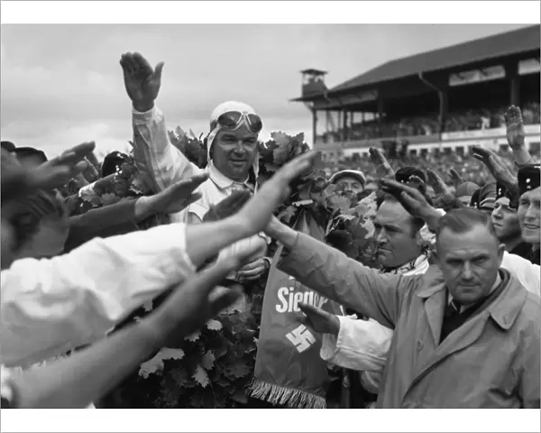 1939 German Grand Prix - Rudolf Caracciola: Rudolf Caracciola salutes the Fuhrer after his race win. It was the last victory of his career