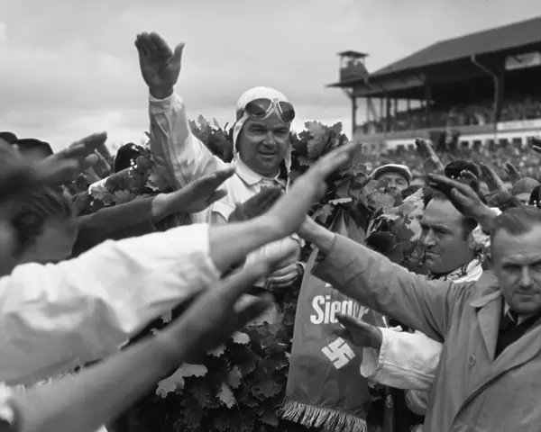1939 German Grand Prix - Rudolf Caracciola: Rudolf Caracciola salutes the Fuhrer after his race win. It was the last victory of his career