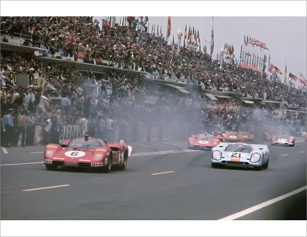 Le Mans, France. 13th - 14th June 1970: L to R: Ignazio Giunti  /  Nino Vaccarella, retired, leads Pedro Rodriguez  /  Leo Kinnunen, retired, ath the start of the race
