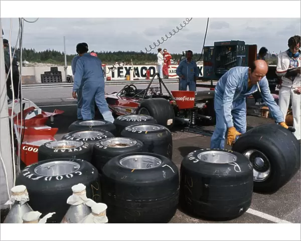 1976 Swedish Grand Prix: Ferrari 312 T2 cars in the paddock with their Goodyear tyres being changed, portrait