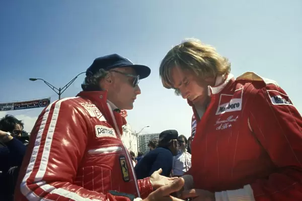 1976 United States Grand Prix West: Niki Lauda and James Hunt talk in the pits before the race, portrait
