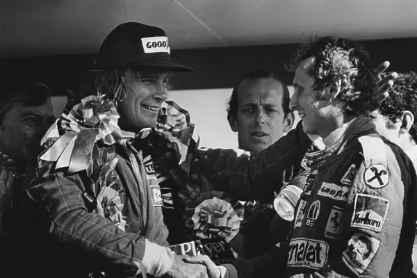 1976 British Grand Prix: James Hunt, Disqualified and Niki Lauda, 1st position celebrate on the podium, portrait