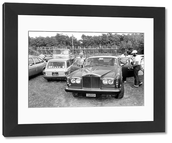 Monza, Italy. 10 September 1978: Mario Andretti gives Colin Chapman and Ronnie Peterson a lift in his Rolls-Royce