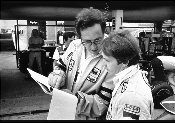 1980 German Grand Prix: Gilles Villeneuve with team director Mauro Forghieri in the pits, portrait