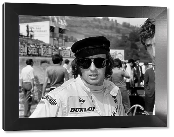 1969 French Grand Prix: Jochen Rindt, 1st position, chats to Jackie Stewart, in the pits, portrait