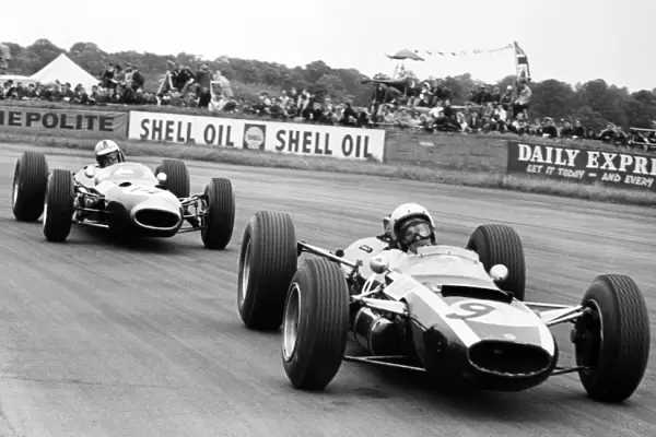 Silverstone, Great Britain. 10 July 1965: Bruce McLaren, Cooper T77-Climax, 10th position, leads Denny Hulme, Brabham BT7-Climax, retired, action