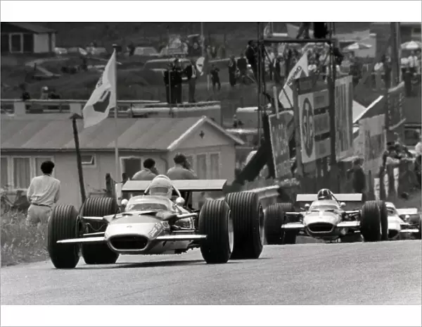 Zandvoort, Holland. 21 June 1969: Jochen Rindt, Lotus 49B-Ford, retired, leads Graham Hill, Lotus 49B-Ford, 7th position, and Jackie Stewart