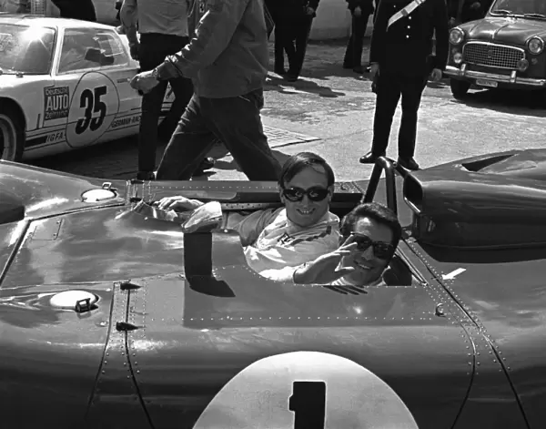 1969 Monza 1000 kms: Chris Amon gives team mate, Mario Andretti a lift through the paddock in their Ferrari 312P, retired, portrait
