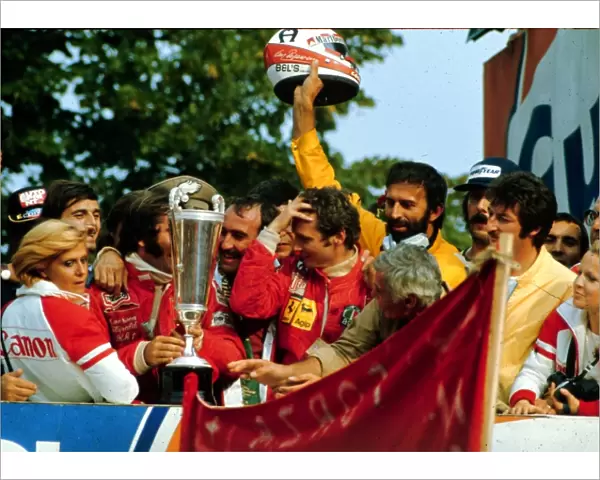 The winners celebrate on the podium in Monza. Race winner Clay Reggazoni