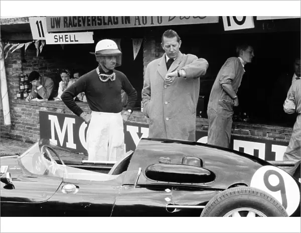 Zandvoort, Holland. 25 May 1958: Team Owner Rob Walker checks the time with his driver Maurice Trintignant, Cooper T45-Climax, 9th position, portrait