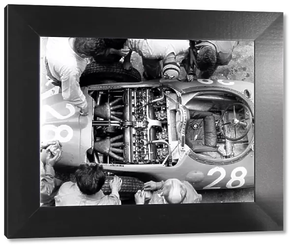 1956 French Grand Prix: Mechanics look at the straight 8 Bugatti 251 engine in Trintignants Bugatti Type 251 chassis