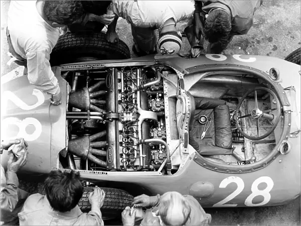1956 French Grand Prix: Mechanics look at the straight 8 Bugatti 251 engine in Trintignants Bugatti Type 251 chassis