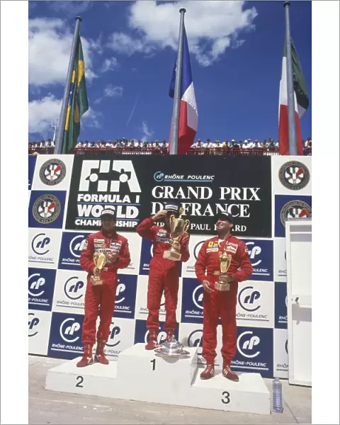 1988 French Grand Prix: Alain Prost, 1st position, celebrates with Ayrton Senna, 2nd position and Michele Alboreto, 3rd position, on the podium
