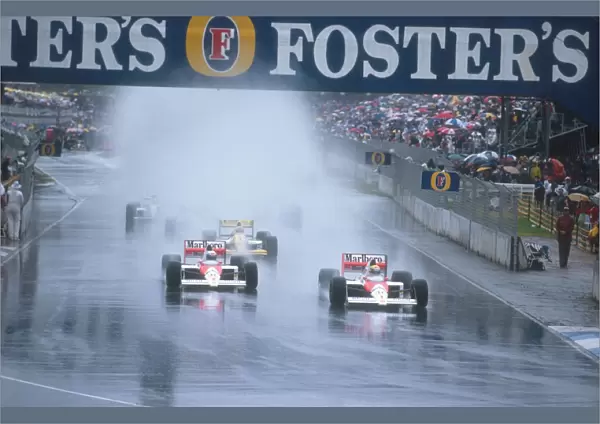 1989 Australian Grand Prix: Ayrton Senna leads teammate Alain Prost with Pierluigi Martini behind in the spray at the start