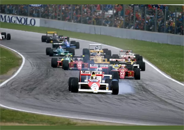 1989 San Marino Grand Prix: Ayrton Senna locks up at Tosa whilst leading the field. Ref-89 SM 07