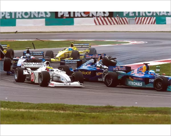 2000 Malaysian Grand Prix: Pedro de la Rosas is lauched into the air as Pedro Dinizs front wheel lands on Jean Alesi s