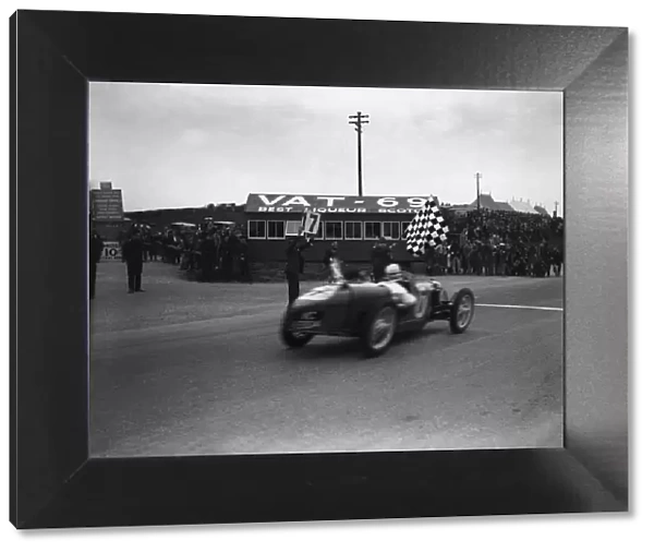 1932 Tourist Trophy: Cyril Whitcroft, 1st position, takes the chequered flag, action