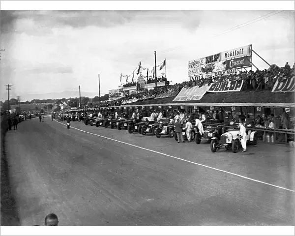 Ards, Northern Ireland, Great Britain. 7 September 1935: The cars line up in front of the pits with WT McCalla and Freddie Dixon  /  Walter Handley to the fore