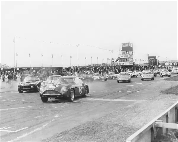 1961 RAC Tourist Trophy: Jim Clark, 4th position, leads Stirling Moss, 1st position, at the strart of the 109 lap race, action