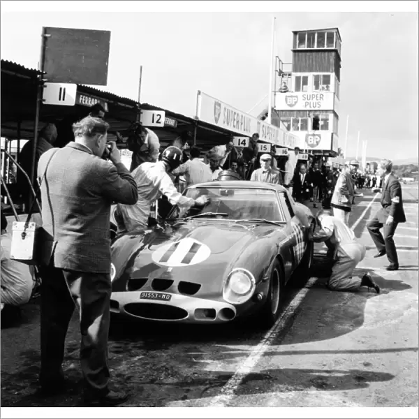 Goodwood, West Sussex, Great Britain. 24 August 1963: Graham Hill, Ferrari 250GTO, 1st position, pitstop, action