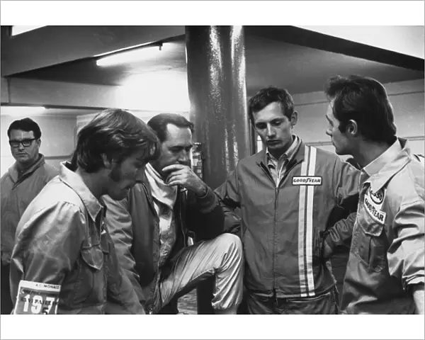 1970 Monaco Grand Prix: Jack Brabham 2nd position, chats with a young Ron Dennis in the pits, portrait