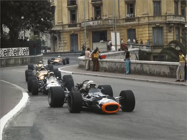 1969 Monaco Grand Prix: John Surtees, BRM P138, leads Jack Brabham, Brabham BT26A Ford, Bruce McLaren, McLaren M7C Ford, and Denny Hulme, McLaren