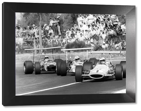 1968 Mexican Grand Prix: Denny Hulme, McLaren M7A-Ford, retired, leads John Surtees, Honda RA301, retired, and Jack Brabham, Brabham BT26-Repco
