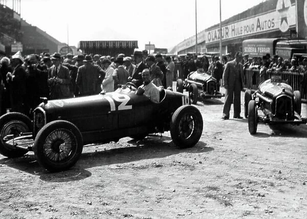 1934 French Grand Prix. Montlhery, France. 1 July 1934. The Alfa Romeo Tipo-B 'P3' cars of Louis Chiron (in car), Carlo Felice Trossi and Achille Varzi arrive for scrutineering