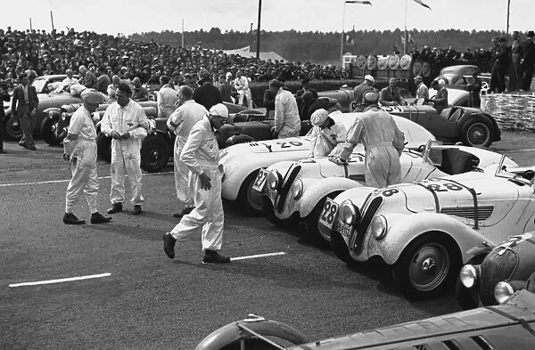 1939 Le Mans 24 Hours: Cars line up in the paddock before the start of the raece. Here two BMW 328 are lined up next to a BMW 328 Touring Coupe