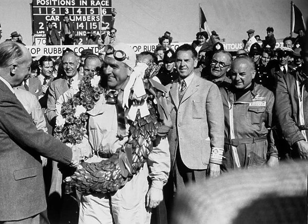 1950_GB_Grand_Prix: Giuseppe Farina 1st position, on the podium after winning the first ever World Championship Grand Prix