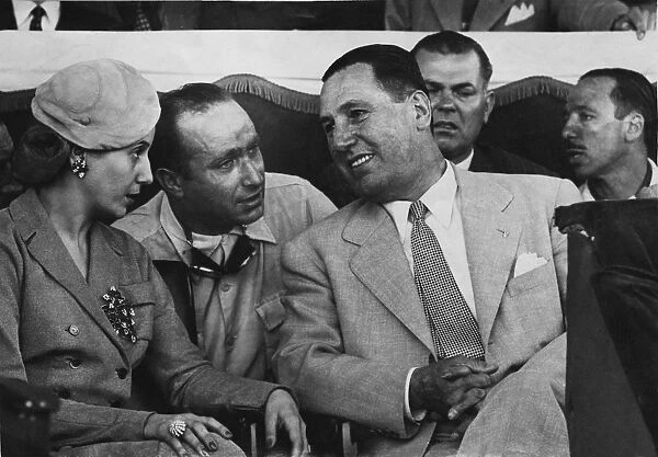 1951 Eva Peron Grand Prix: Juan Manuel Fangio, retired, explains his retirement to the President Juan and Madame Eva Peron in the grandstand