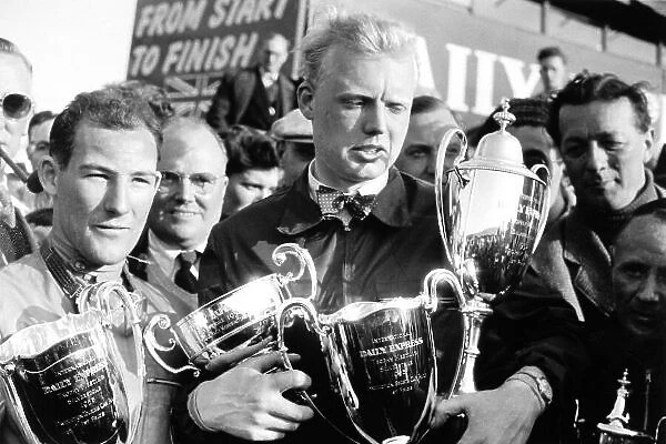 1953 Daily Express International Trophy. Silverstone, Great Britain. 9 May 1953. Stirling Moss, production touring car race winner, and Mike Hawthorn, with various trophies including F2 race winner, portrait