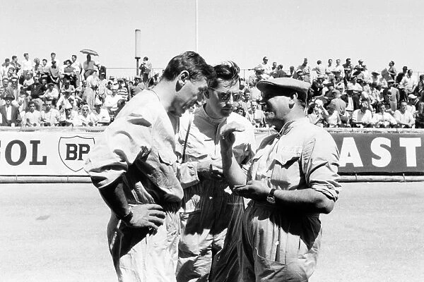 1958 Monaco Grand Prix: Roy Salvadori, Cooper T45-Climax, retired, and Jack Brabham, Cooper T45-Climax, 4th position, talk to a mechanic, portrait