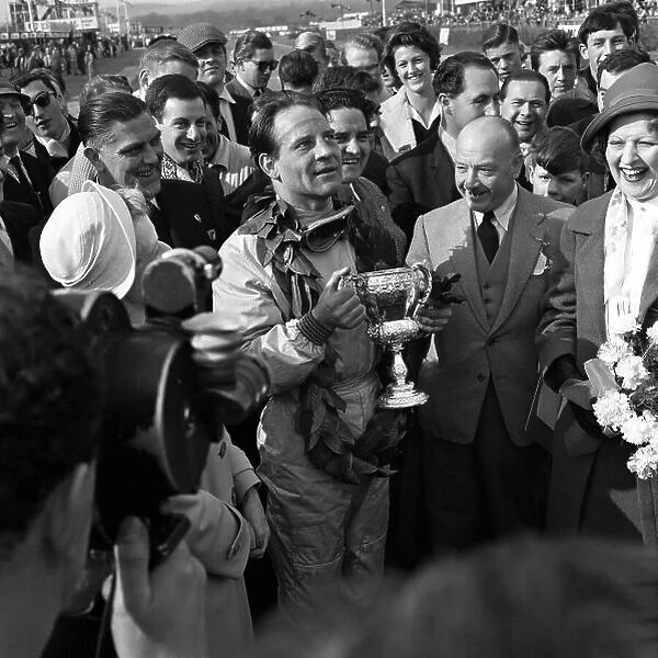 1960 Glover Cup. Goodwood, W, Sussex, England. 18th April 1960. Innes Ireland (Lotus 18-Climax), 1st position, celebrates in the paddock with the Glover Trophy, portrait. World Copyright: LAT Photographic. Ref: 6177