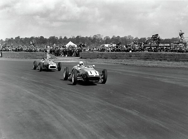 1960 International Trophy. Silverstone, England. 14th May 1960. Alan Stacey (Lotus 18 - Climax), 4th position, leads John Surtees (Lotus 18 - Climax), retired, action. World Copyright: LAT Photographic. Ref: Autocar Glass Plate C58121