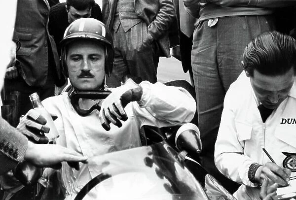 1962 Dutch Grand Prix. Zandvoort, Holland. 18-20 May 1962. Graham Hill (BRM P57), 1st position, recieves a drink in parc ferme, portrait. World Copyright: LAT Photographic Ref: 10151