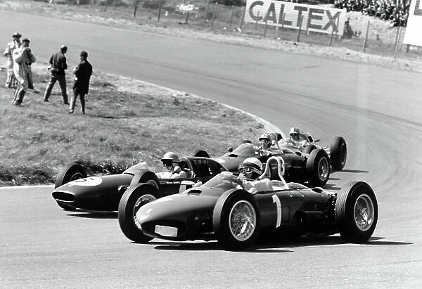 1962 Dutch Grand Prix. Zandvoort, Holland. 18-20 May 1962. Phil Hill (#1 Ferrari Dino 156) takes a wide line through Tarzan Corner. Trevor Taylor (Lotus 24-Climax)