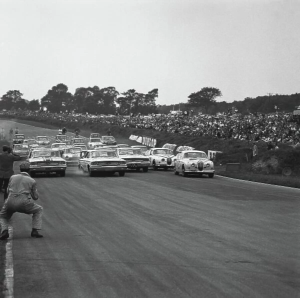 1963 British Saloon Car Championship. Brands Hatch, England. 5th August 1963. Rd 8. L to R: Jack Sears (Ford Galaxie), retired, Jim Clark (Ford Galaxie), 1st position and Graham Hill (Jaguar Mk II 3.8), 2nd position, lead at the start of the race