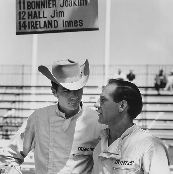 1963 Monaco Grand Prix - Innes Ireland and Jim Hall: Innes Ireland, retired, talks to team mate Jim Hall, retired, portrait