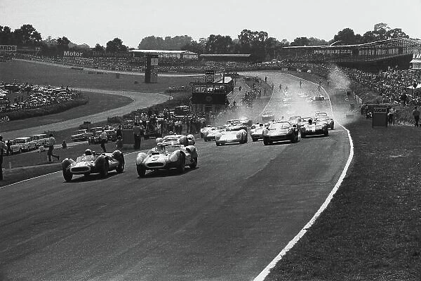 1964 Guards International Trophy. Brands Hatch, England. 3rd August 1964. Walt Hausgen (Lotus 19 Oldsmobile), retired leads Bruce McLaren (Zerex Special Oldsmobile), 1st position at the start of the race, action. World Copyright: LAT Photographic