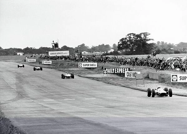 1965 British Grand Prix. Silverstone, Great Britain. 10 July 1965. John Surtees, Ferrari 1512, 3rd position, leads Jim Clark, Lotus 33-Climax, 1st position, action. World Copyright: LAT Photographic
