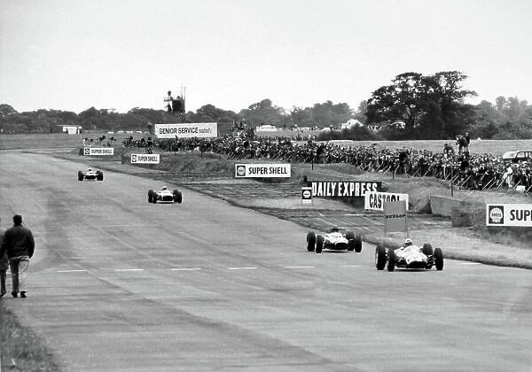 1965 British Grand Prix. Silverstone, Great Britain. 10 July 1965. Ian Raby, Brabham BT3-BRM, 11th position, leads a group of cars, action. World Copyright: LAT Photographic