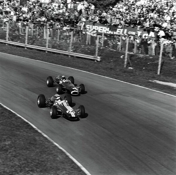 1965 Italian Grand Prix. Monza, Italy. 12th September 1965. Jim Clark (Lotus 33-Climax), retired, leads Jackie Stewart (BRM P261), 1st position, action. World Copyright: LAT Photographic. Ref: 30805