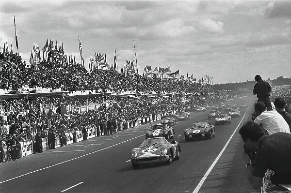 1965 Le Mans 24 Hours. Le Mans, France. 19th - 20th June 1965. Lucien Bianchi / Mike Salmon (Ferrari 250 LM), retired, leads Jean de Mortemart / Regis Fraissinet (Iso Grifo A3C), 9th position, at the start of the race, action