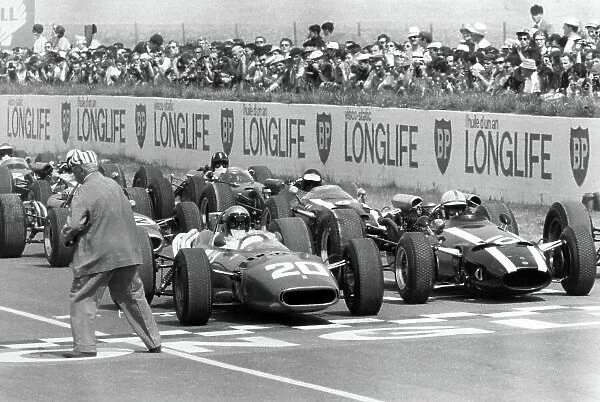 1966 French Grand Prix. Reims, France. 3 July 1966. Lorenzo Bandini, Ferrari 312, not classified, and John Surtees, Cooper T81-Maserati, retired, on the front row before the start, action. World Copyright: LAT Photographic Ref: Motor b&w print