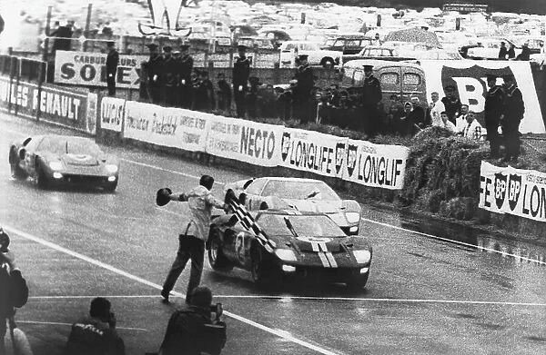 1966 Le Mans 24 Hours: Moment of victory for Fords, the 7 litre Ford GT40 of Bruce McLaren and Chris Amon, crosses the finish line to lead a