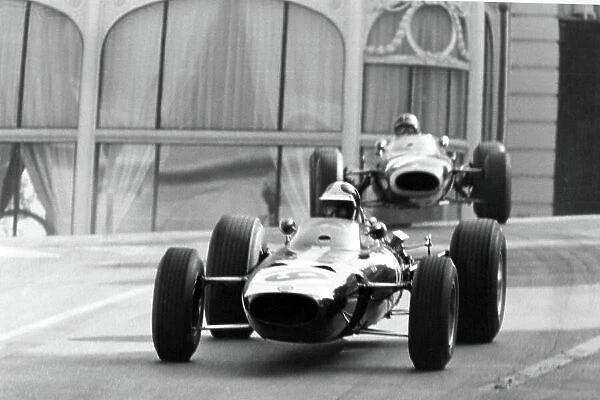 1966 Monaco Grand Prix. Monte Carlo, Monaco. 22 May 1966. Bob Bondurant, BRM P261, 4th position, leads Graham Hill, BRM P261, 3rd position, action. World Copyright: LAT Photographic Ref: Motor b&w print