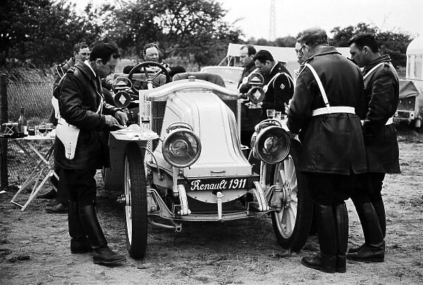 1967 24 Hours of Le Mans: CIRCUIT DE LA SARTHE, FRANCE - JUNE 11: French motorcycle policemen eat their lunch around a vintage 1911 Renault during