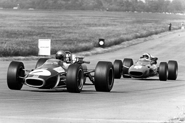 1967 British Grand Prix: Jack Brabham, Brabham BT24-Repco, 4th position, leads Chris Amon, Ferrari 312, 3rd position, action
