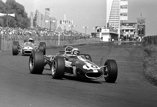 1967 GERMAN GP - NURBURGRING: Bruce McLaren leads World Champion Jack Brabham at the Nurburgring. Brabham finished 2nd behind Denny Hulme